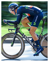 Professional cyclist in blue Movistar team kit riding a Canyon bike at high speed on a road.