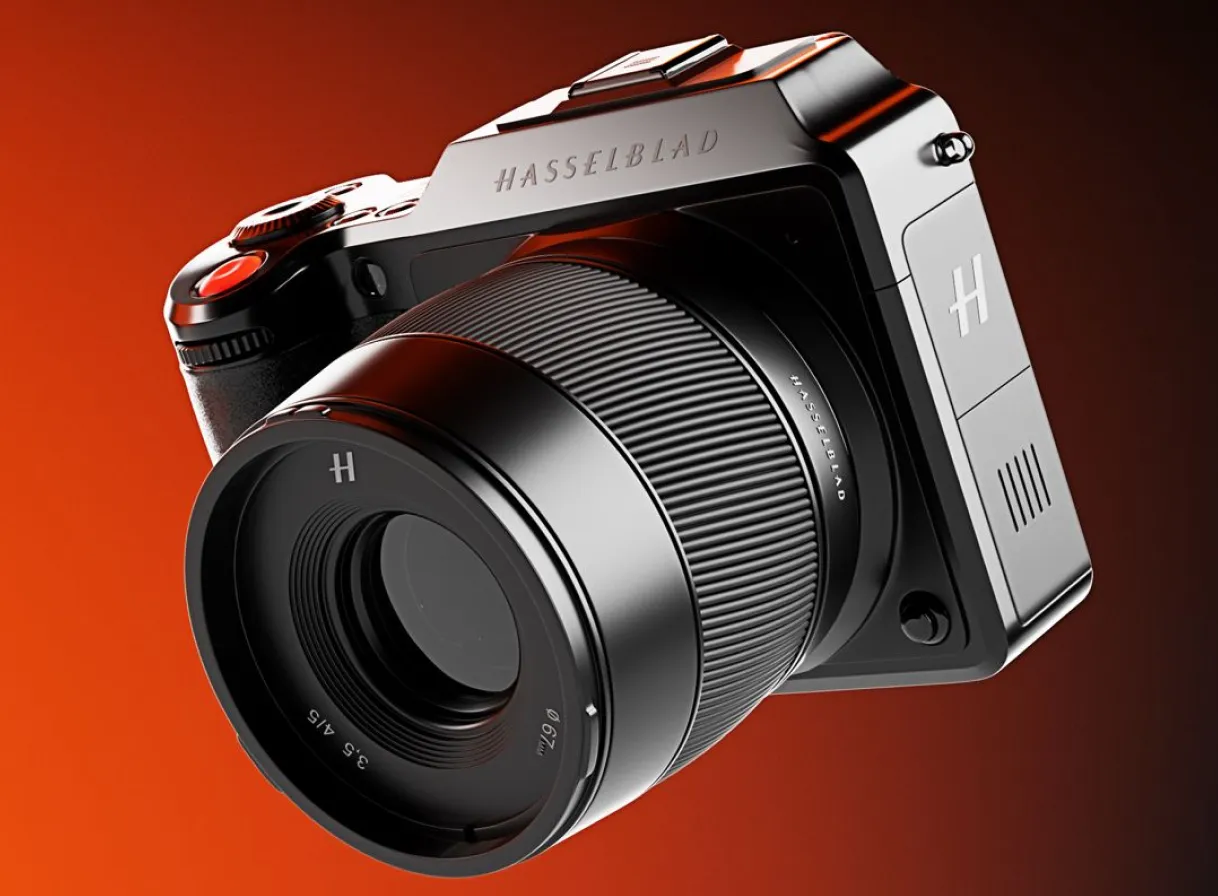 Close-up of a black Hasselblad camera with a large lens against a red gradient background.