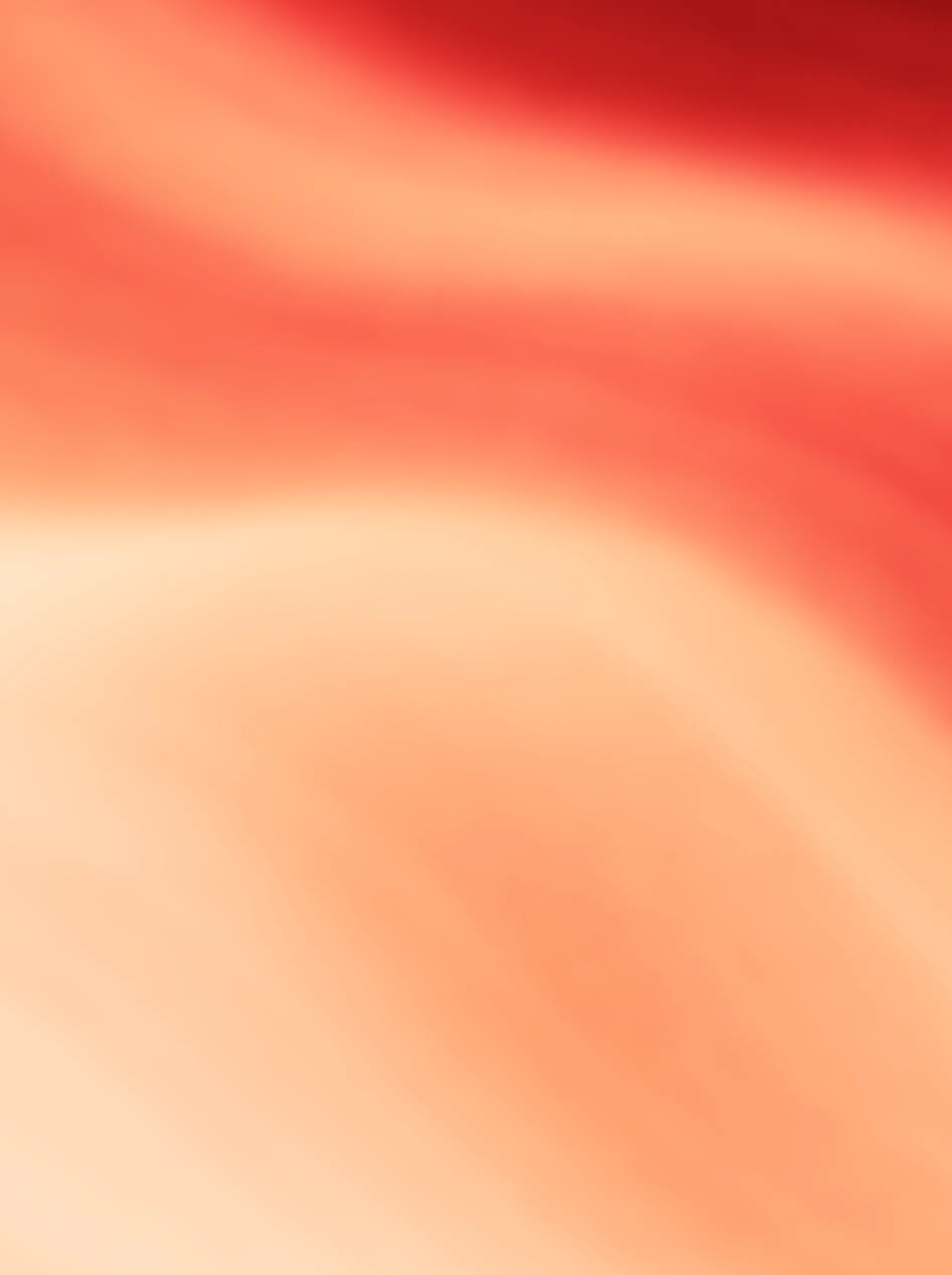 Abstract gradient background with smooth blended shades of red, orange, and peach.