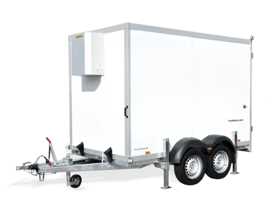 White Humbaur Cool Plus refrigerated trailer with dual axles and cooling unit on front panel.