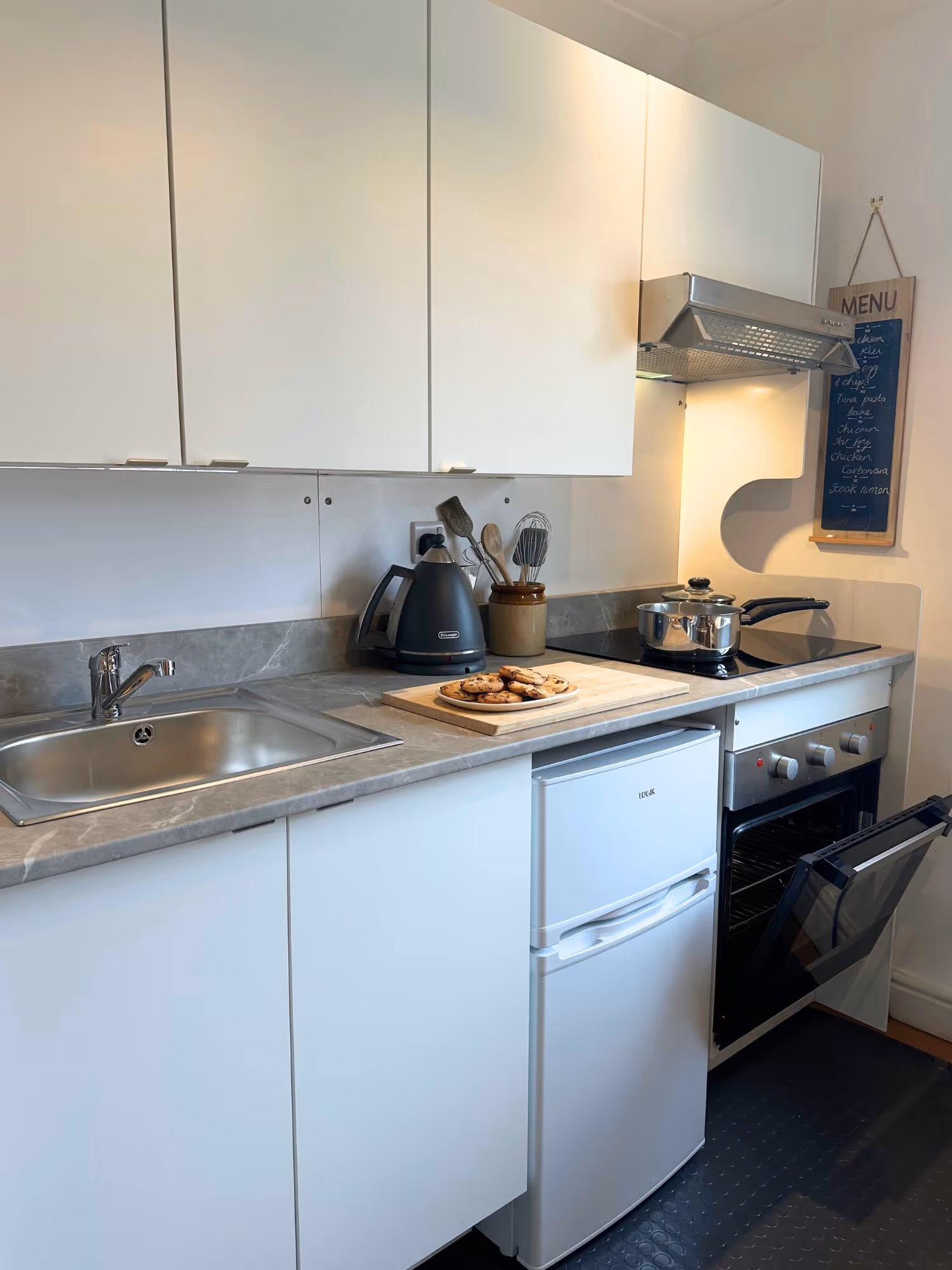 TRU Internal Kitchen fitted with an oven, hob and fridge/freezer