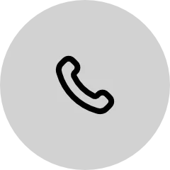 Ícono negro de un teléfono dentro de un círculo gris claro.