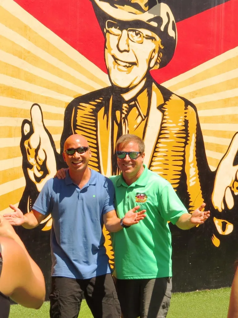 Happy tour guide and customer posing near the Tony Goldman Mural by Shepard Fairey in Wynwood