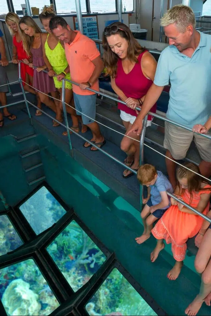 Family with three kids on a glass-botto boat ride