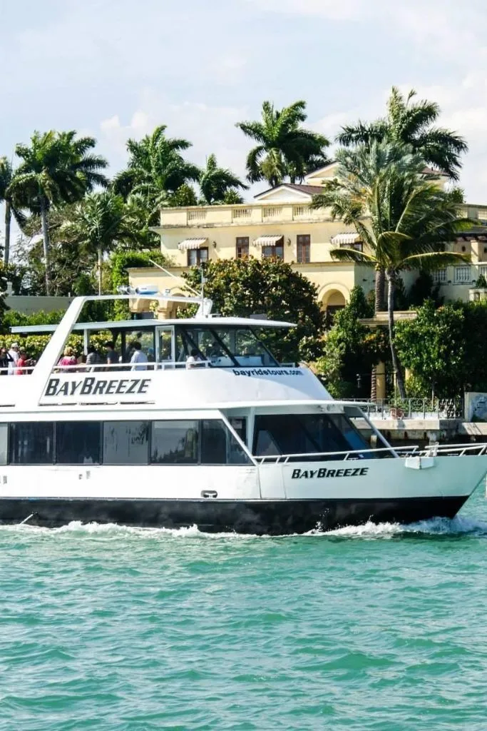 Miami sightseeing boat crusing past mansion