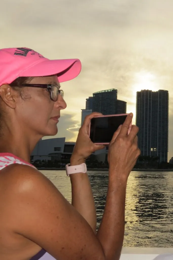 Women taking photo on the Miami skyline at sunset