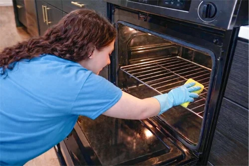 Cleaner cleaning the inside of an oven
