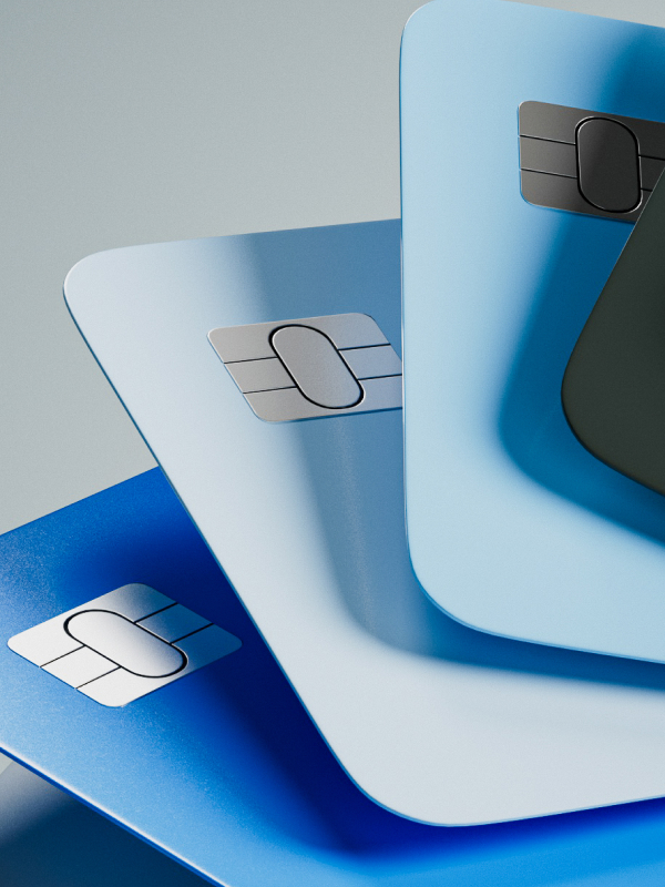 Close-up of several overlapping blue credit cards with visible EMV chip contacts.