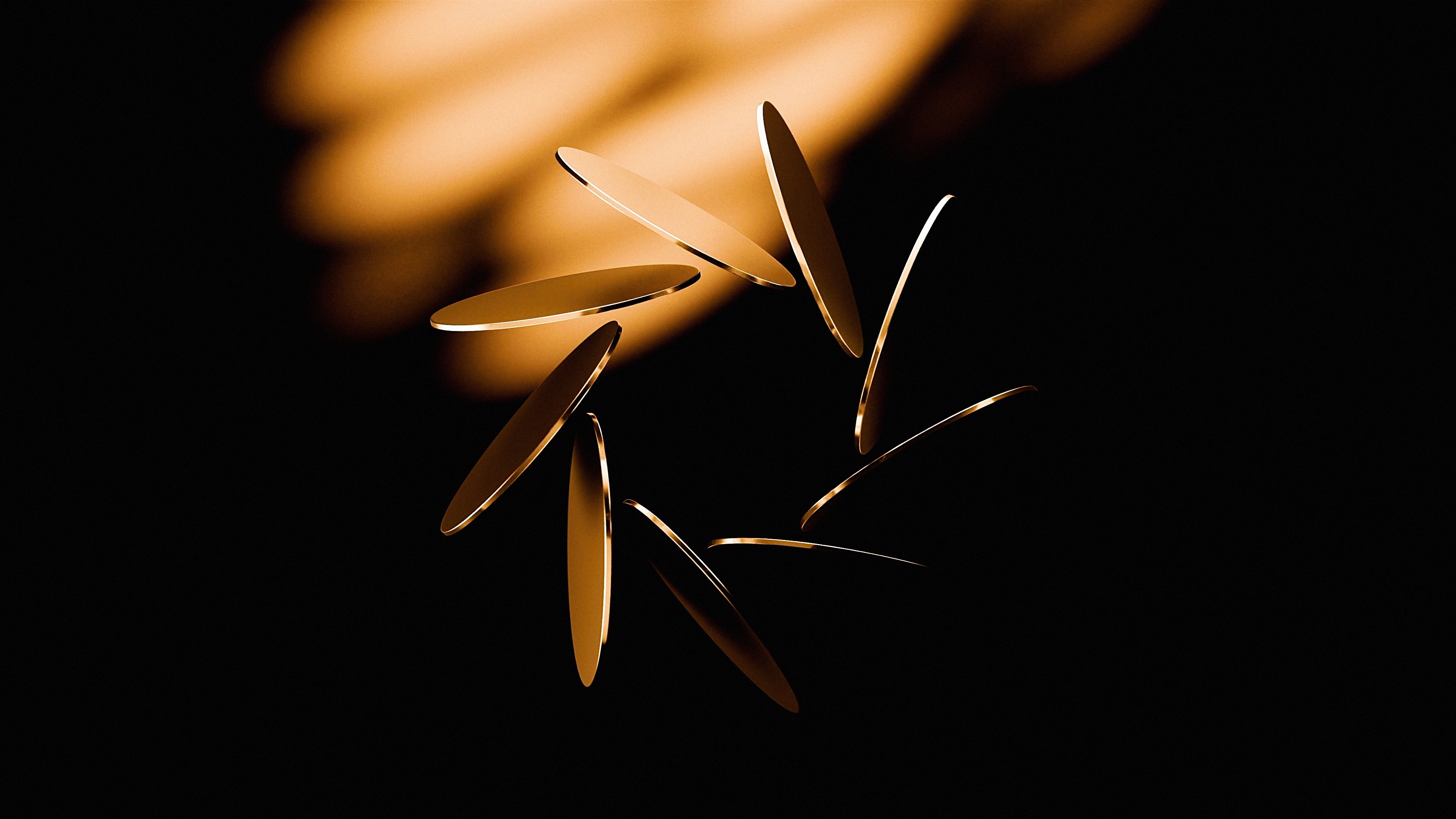 Close-up of multiple golden coins mid-air against a dark background with soft orange light.