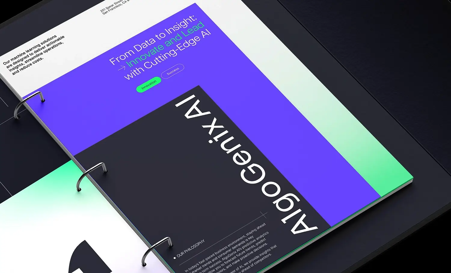 Open binder showing vibrant AI brand design layout in purple and green.