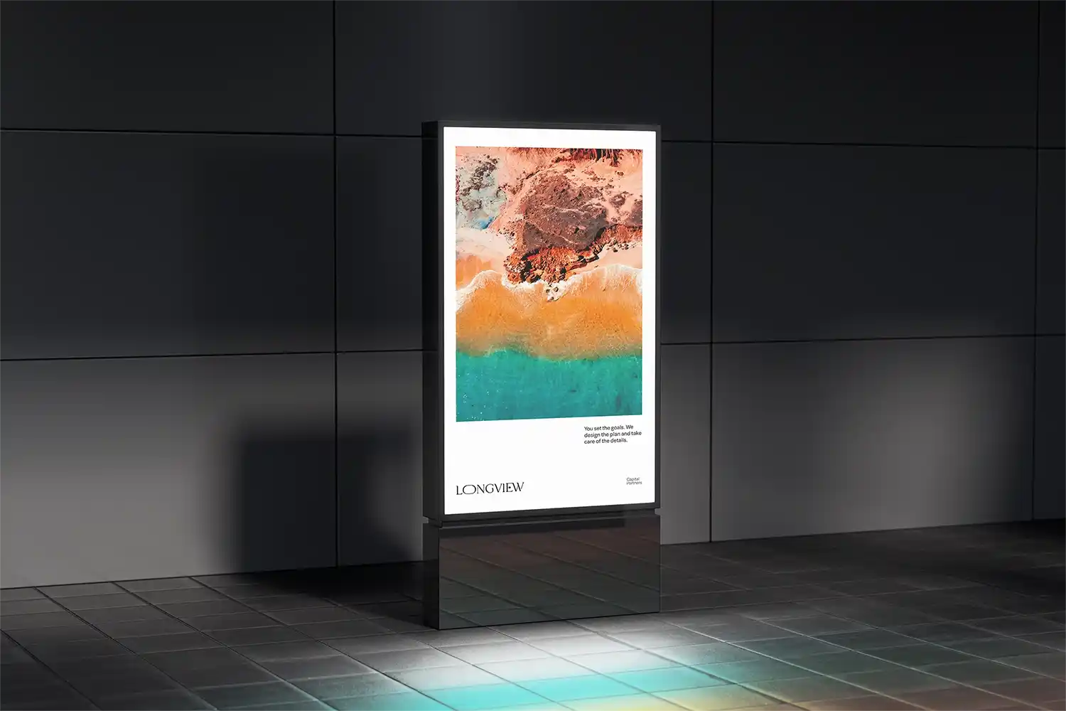 Illuminated poster stand displaying coastal aerial image.