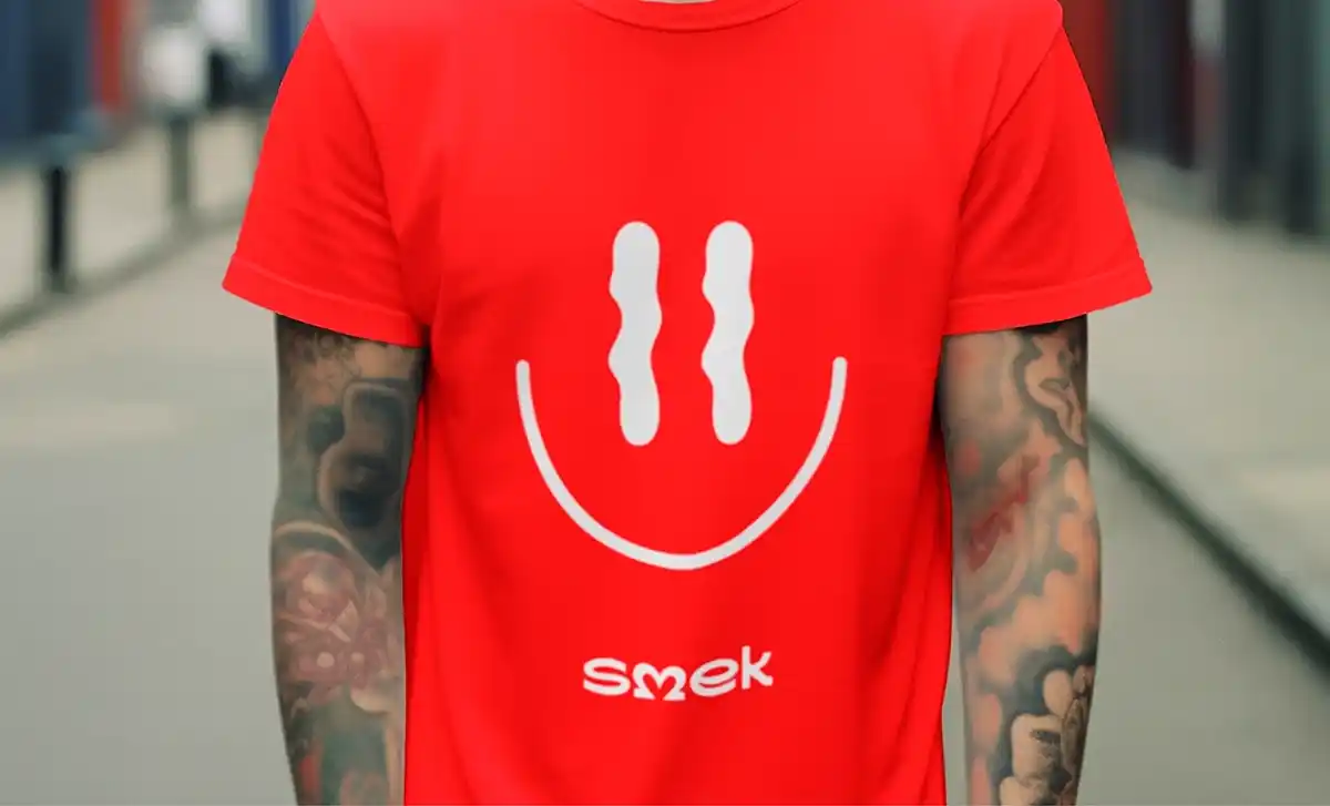 Red t-shirt with white smiley face logo.