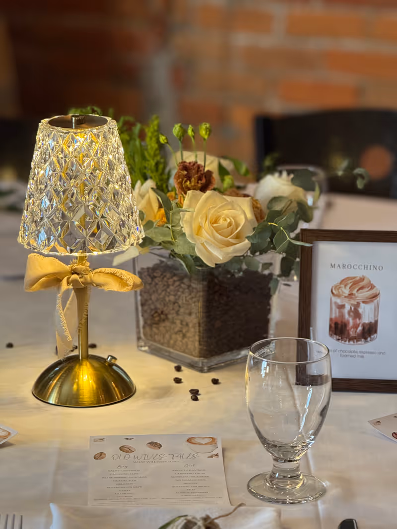 A table topped with a vase filled with flowers.
