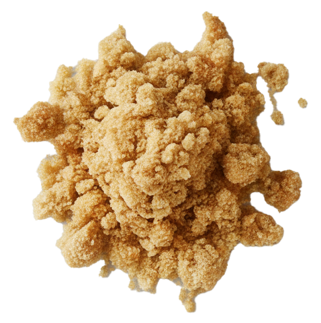 Close-up of light brown crumbly streusel topping on a white surface.