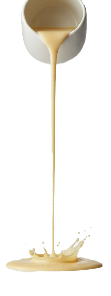 Creamy beige liquid pouring from a white cup, creating a splash on a flat surface below.