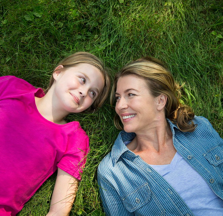 Mother and daughter smiling at each other