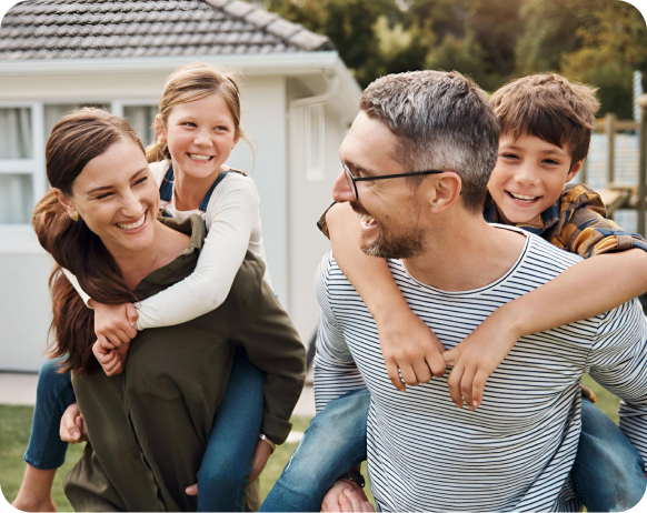 Parents giving their child piggyback ride