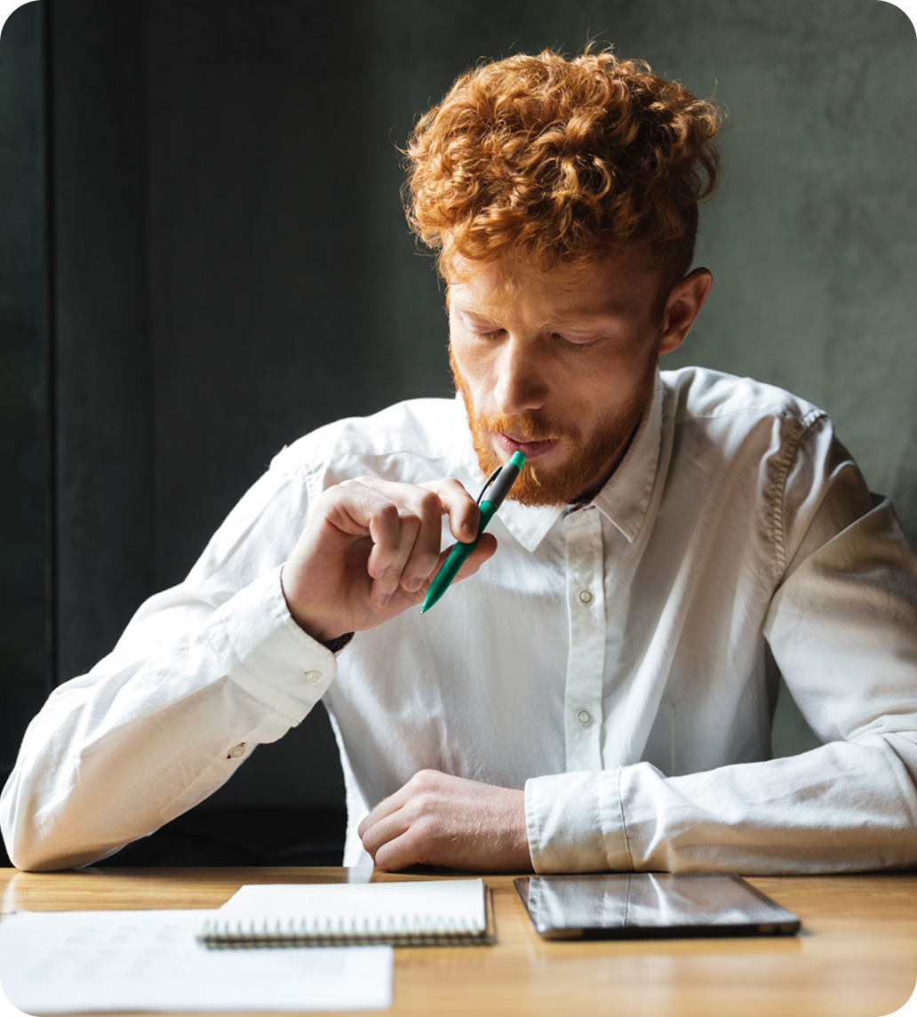 Man biting a pen while thinking