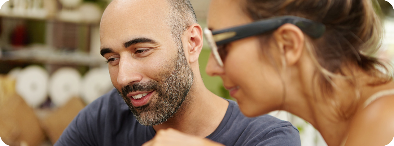 Man and woman watching something together