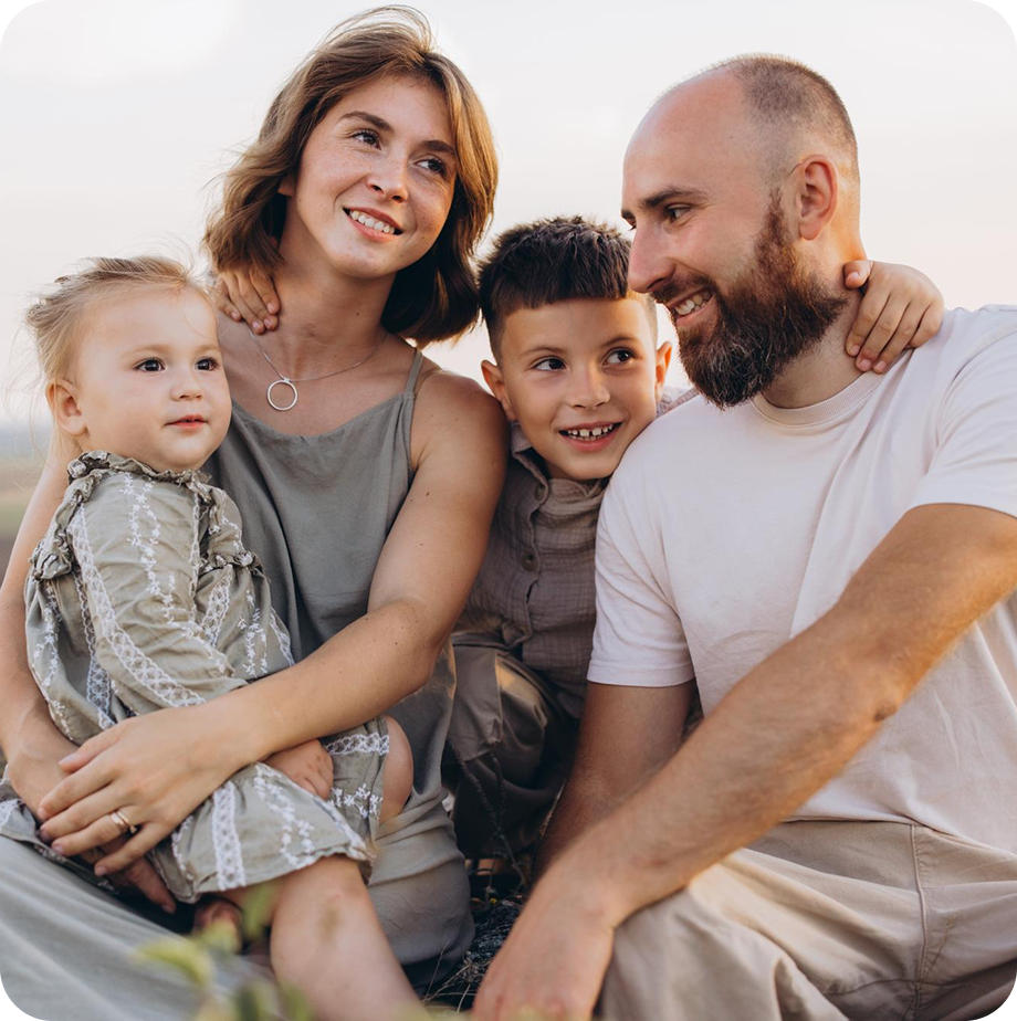 Family of four talking and smiling at each other