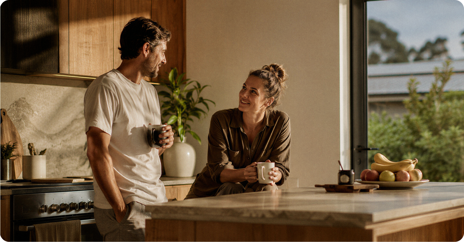 A couple talking over coffee in their kitchen