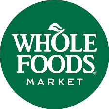 Whole Foods Market logo with white text on a green circular background.