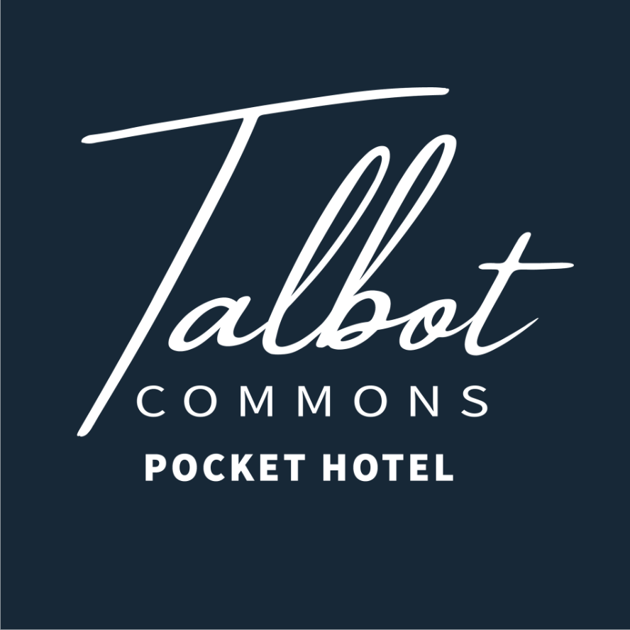 Logo with the text 'Talbot Commons Pocket Hotel' on a dark blue background, featuring 'Talbot' in large cursive font.