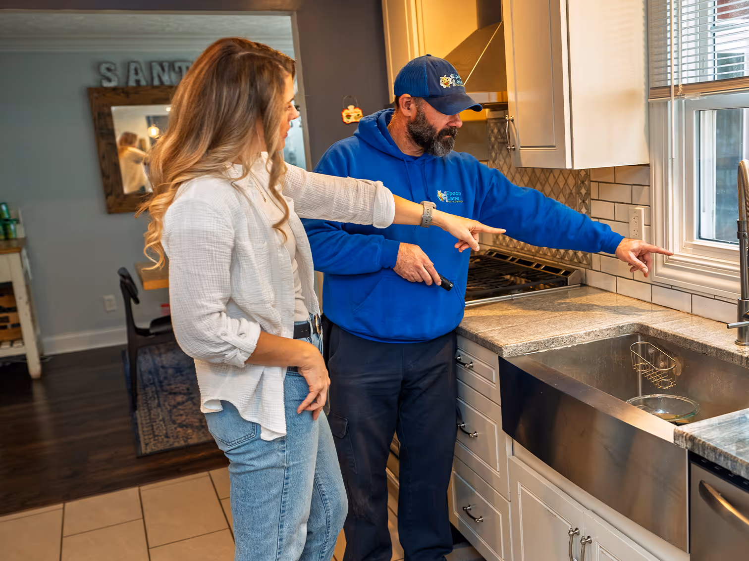 pest control technician with customer in a cleveland home