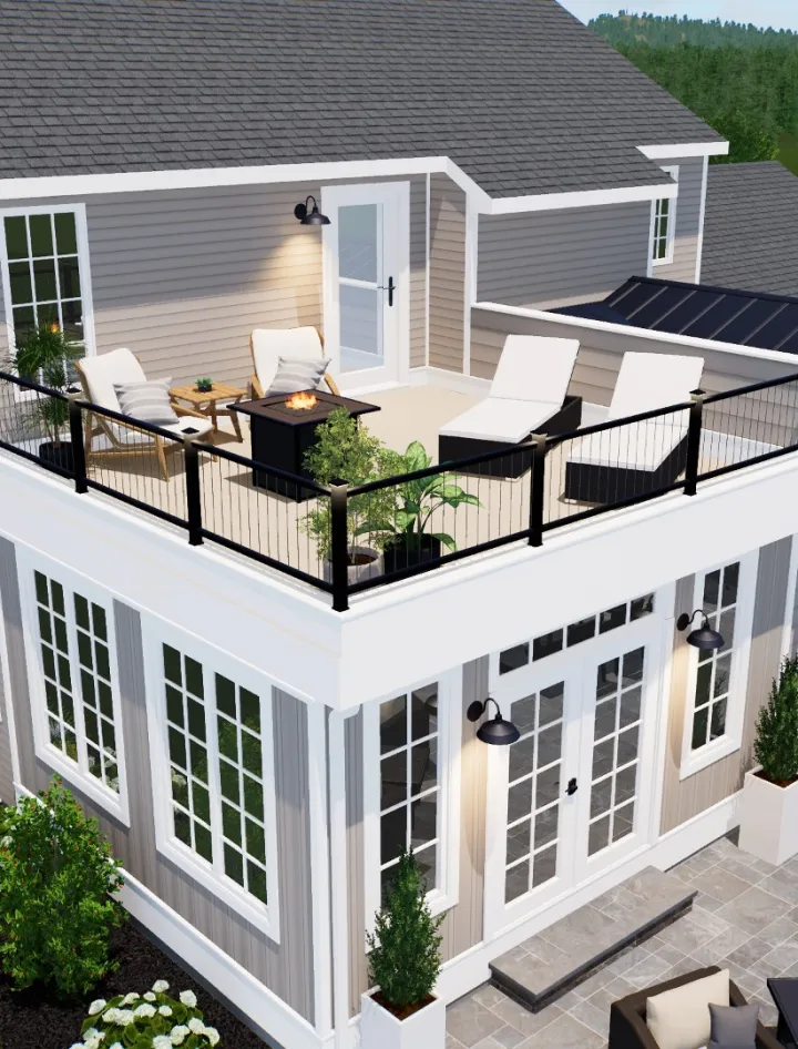 A rooftop patio with lounge chairs, a small table, potted plants, and a fire pit, surrounded by a black railing atop a two-story gray house.