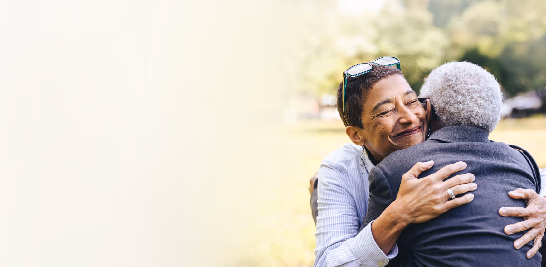 two people hugging outside