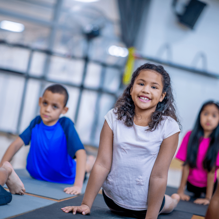 Kids doing upward dog in yoga