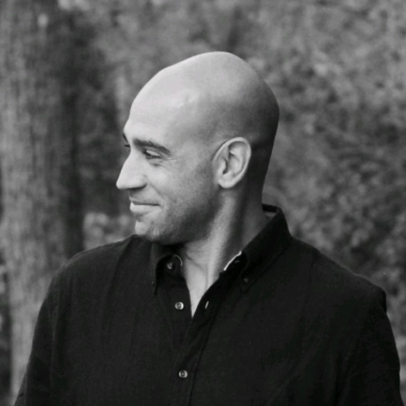 A mesmerizing long-exposure image of star trails, spiraling around a central point against a dark backdrop.