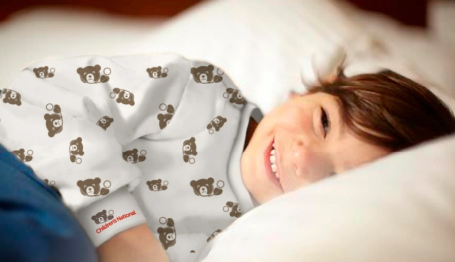 Kid smiling in bed