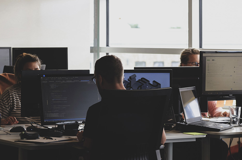 website development team coding together