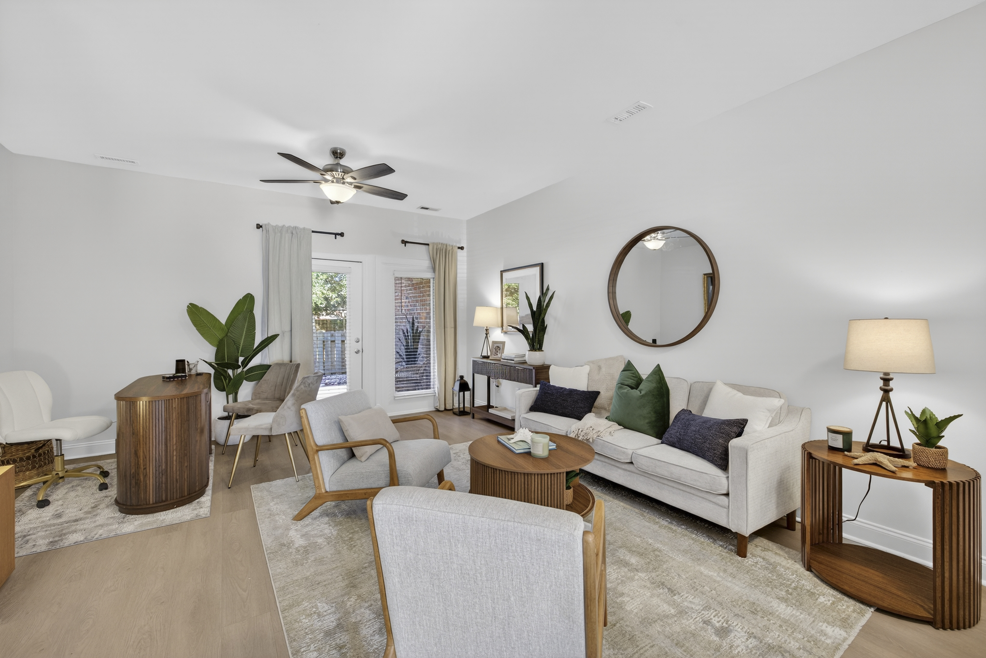 Open concept living room with ceiling fan.