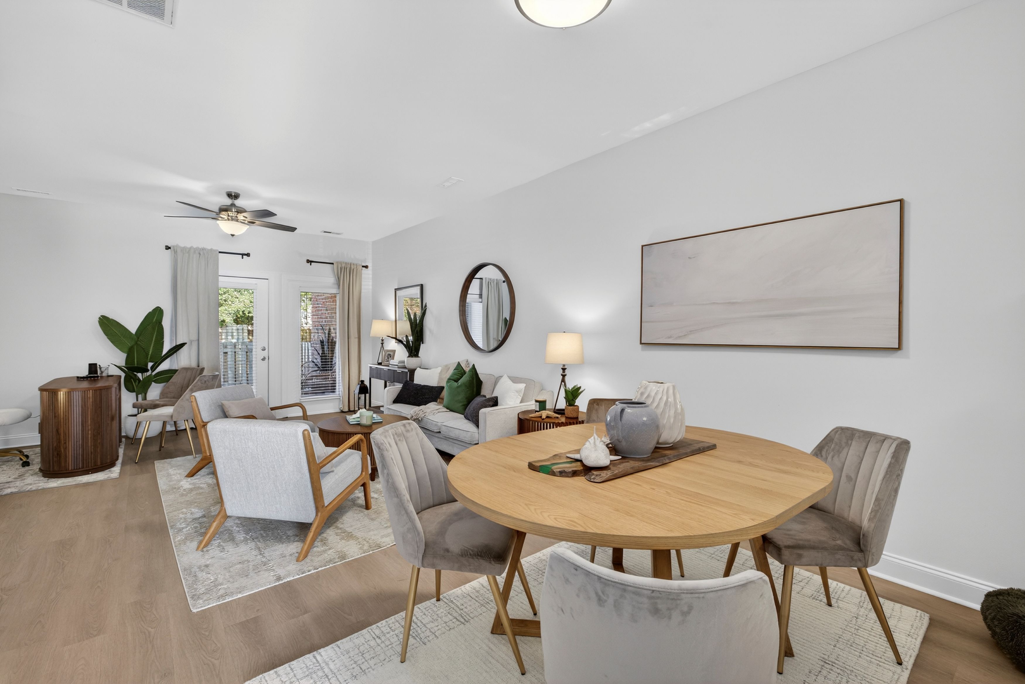 Open concept living room with ceiling fan and walk out patio.