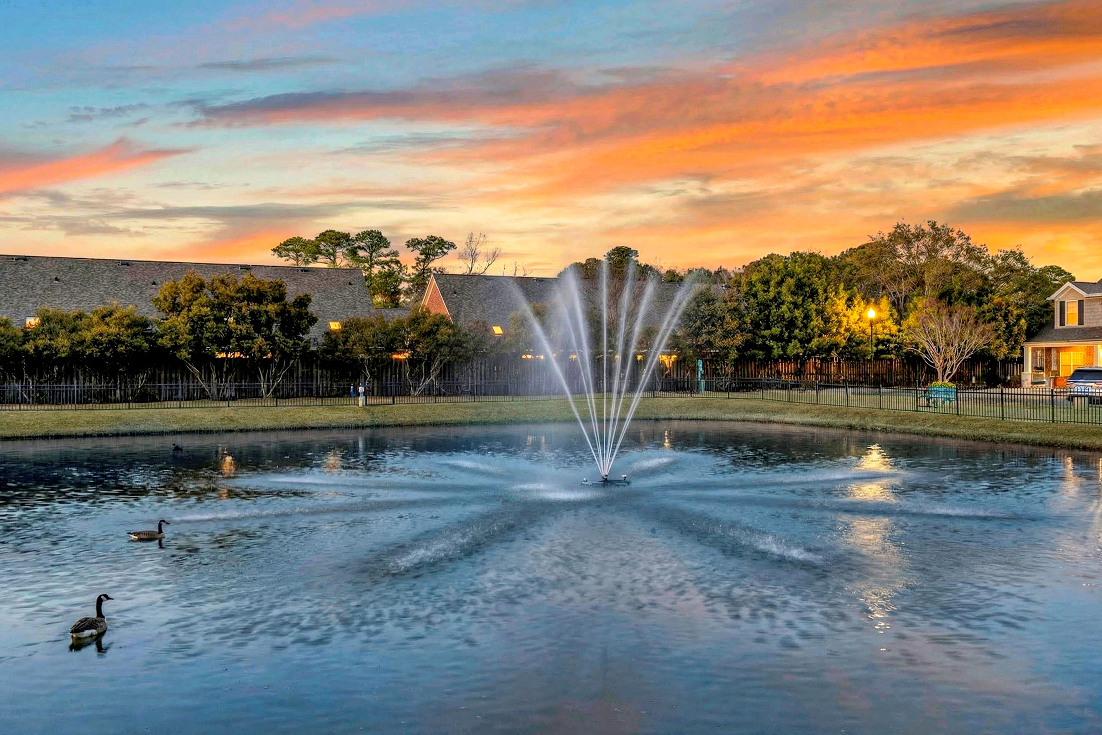 Beautiful sunset at the pond with water fountain feature