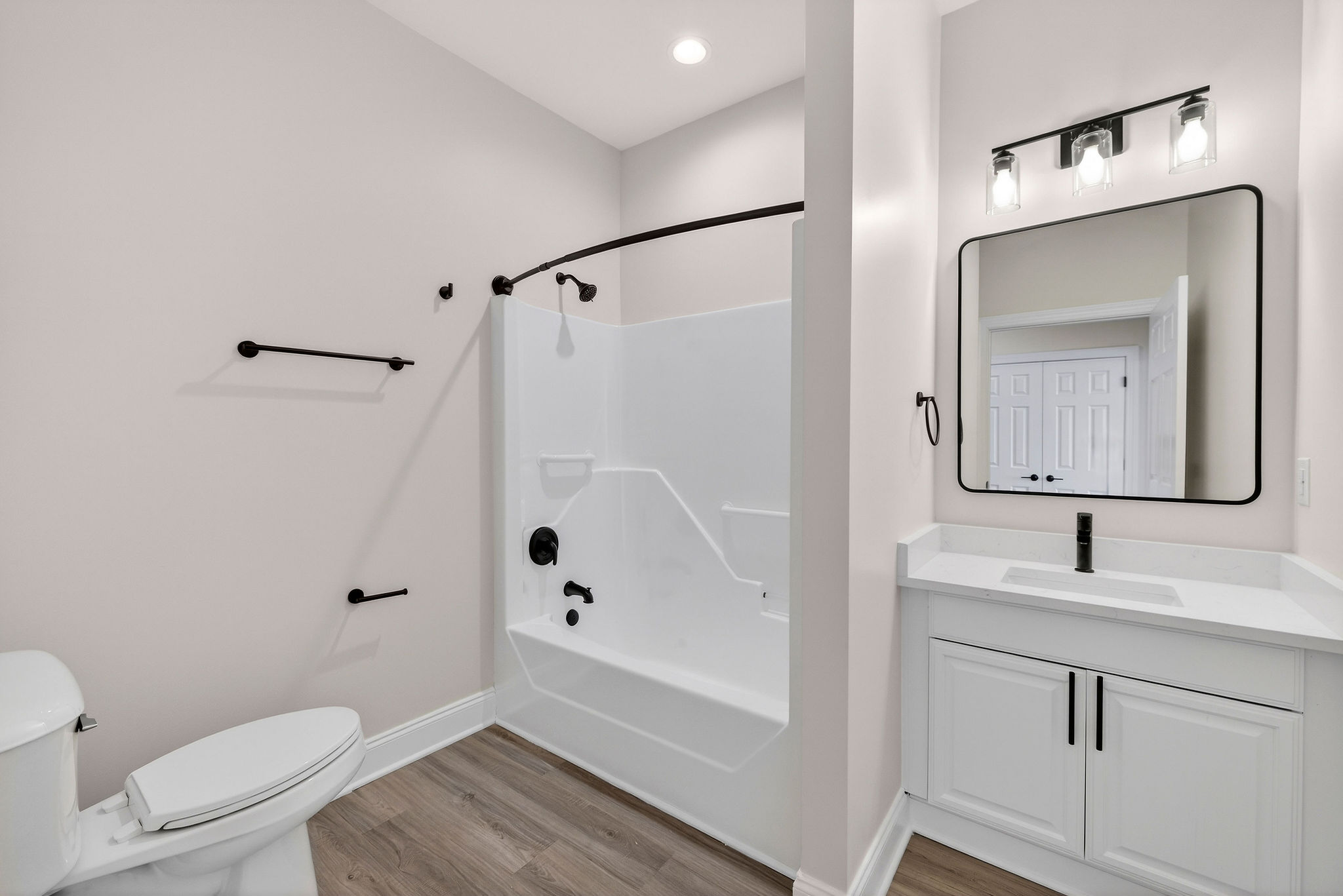 Newly refreshed bathroom with framed vanity mirror