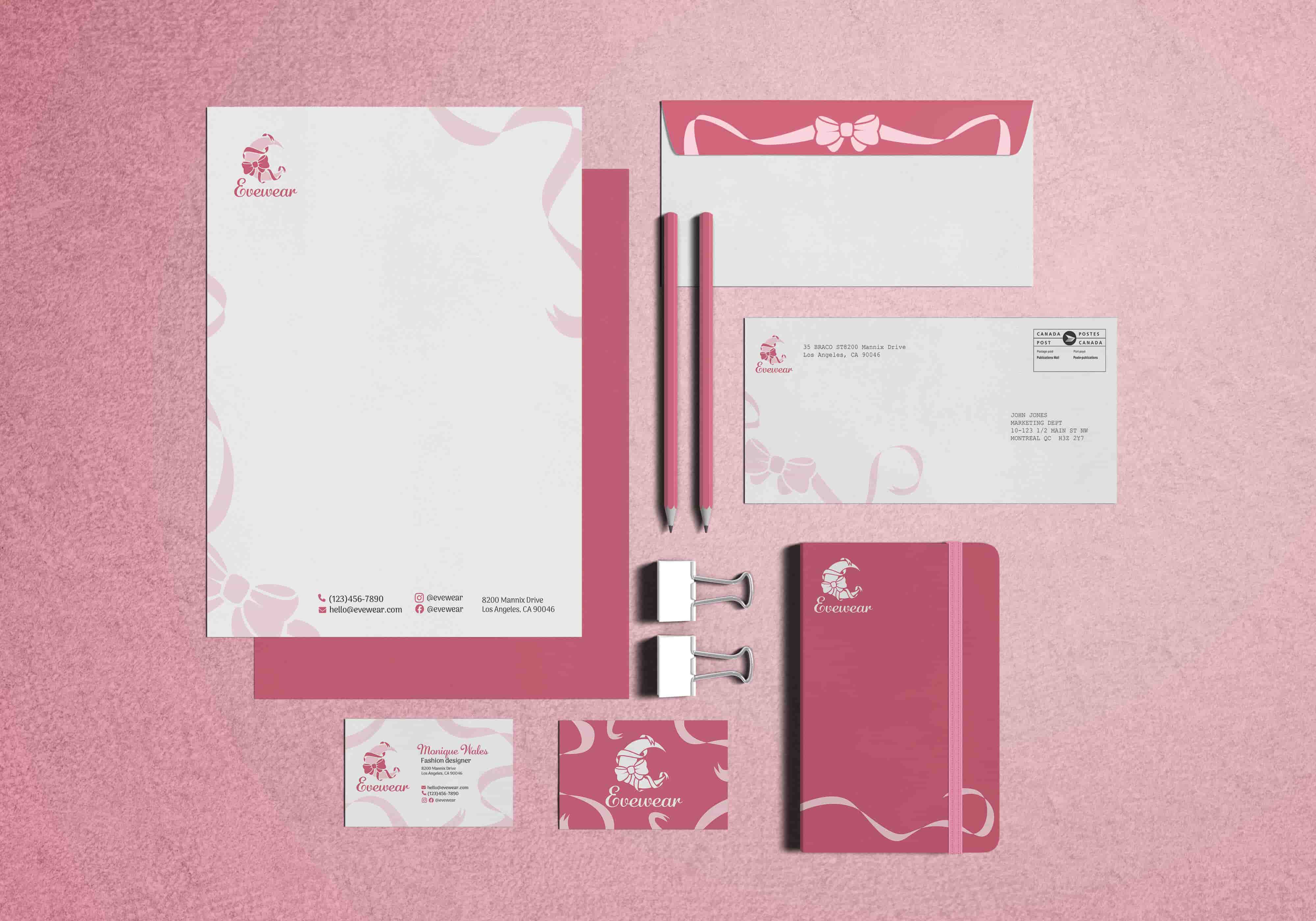 Pink and white branded stationery set including letterhead, envelope, business cards, pens, binder clips, and notebook with ribbon design and Evewear logo.