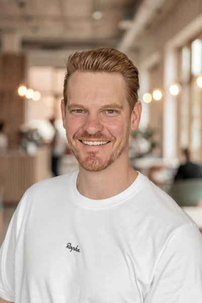 Nate, a smiling bearded man in white t-shirt
