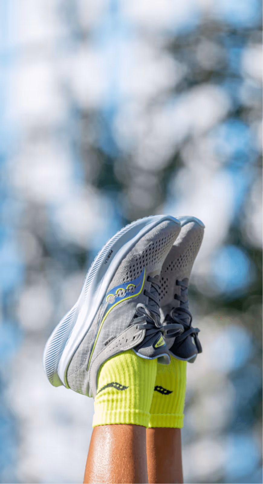 Two legs with shoes pointing towards the sky dangling in the air