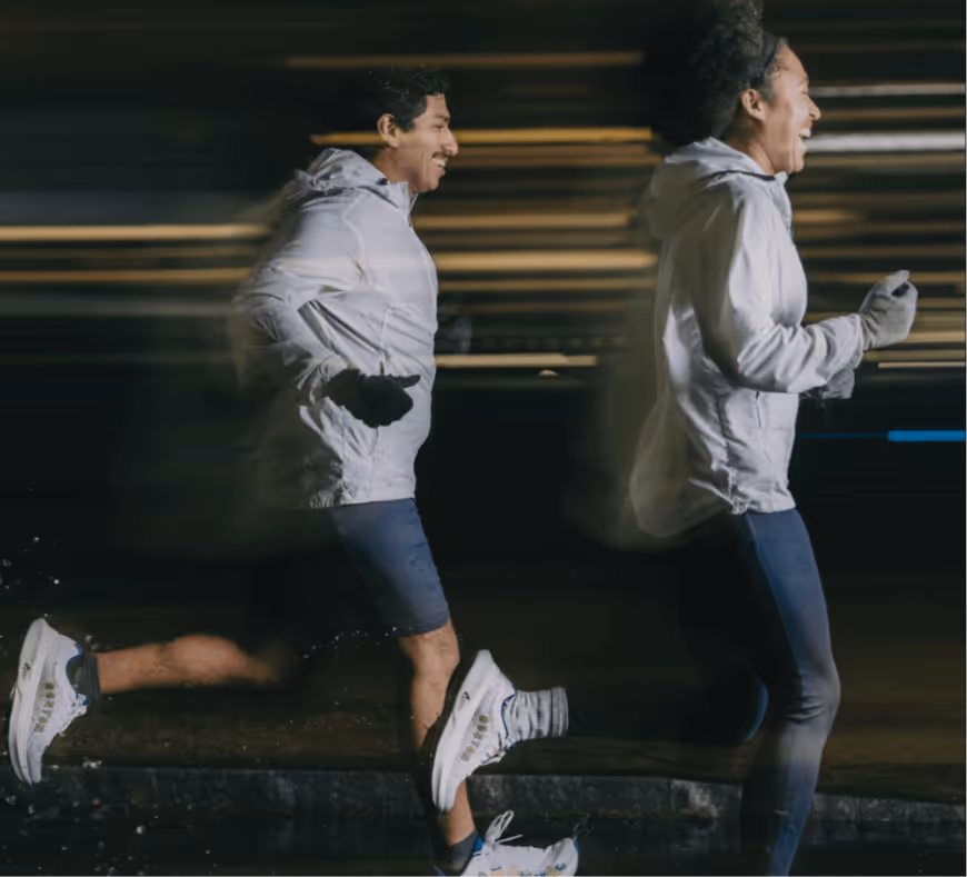 Two people running at night