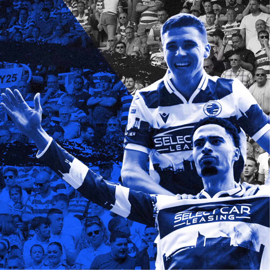 Two jubilant soccer players in striped jerseys celebrating in front of a crowded stadium audience.