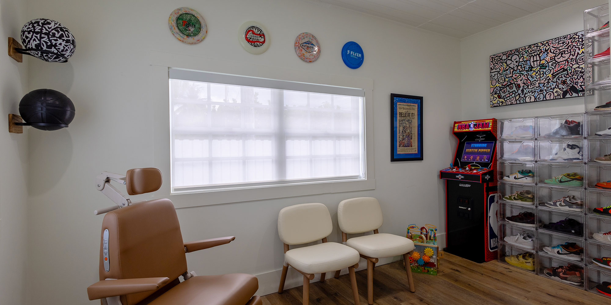 exam room with arcade machine an sneaker collection