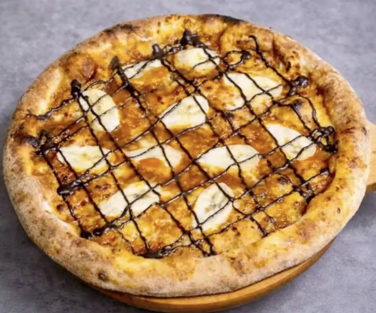 Sweet dessert pizza with a chocolate drizzle