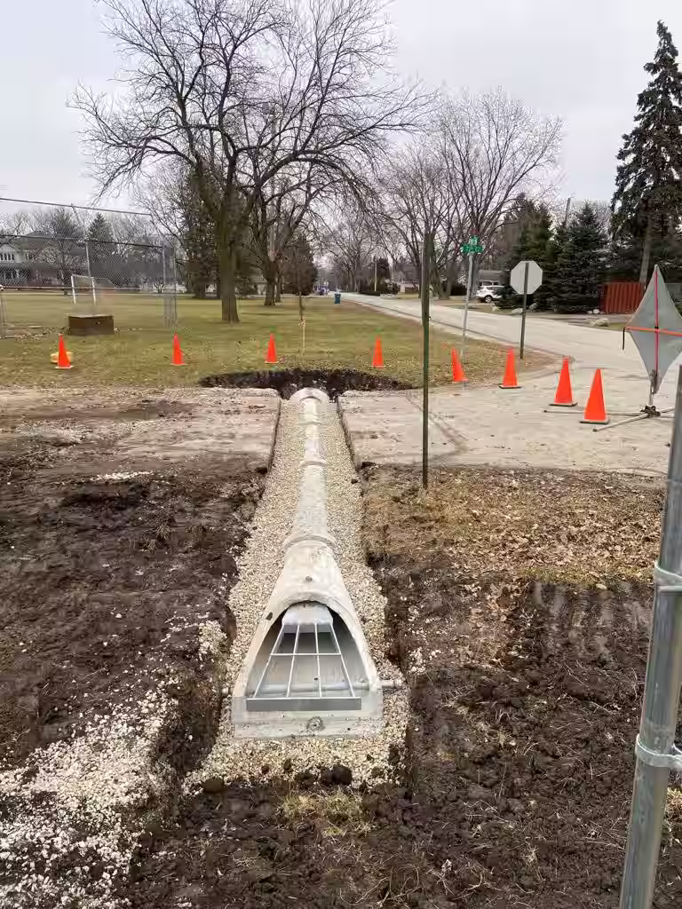 Donegal Services crew performing sewer and water line repairs with traffic control on a busy roadway in Chicagoland.