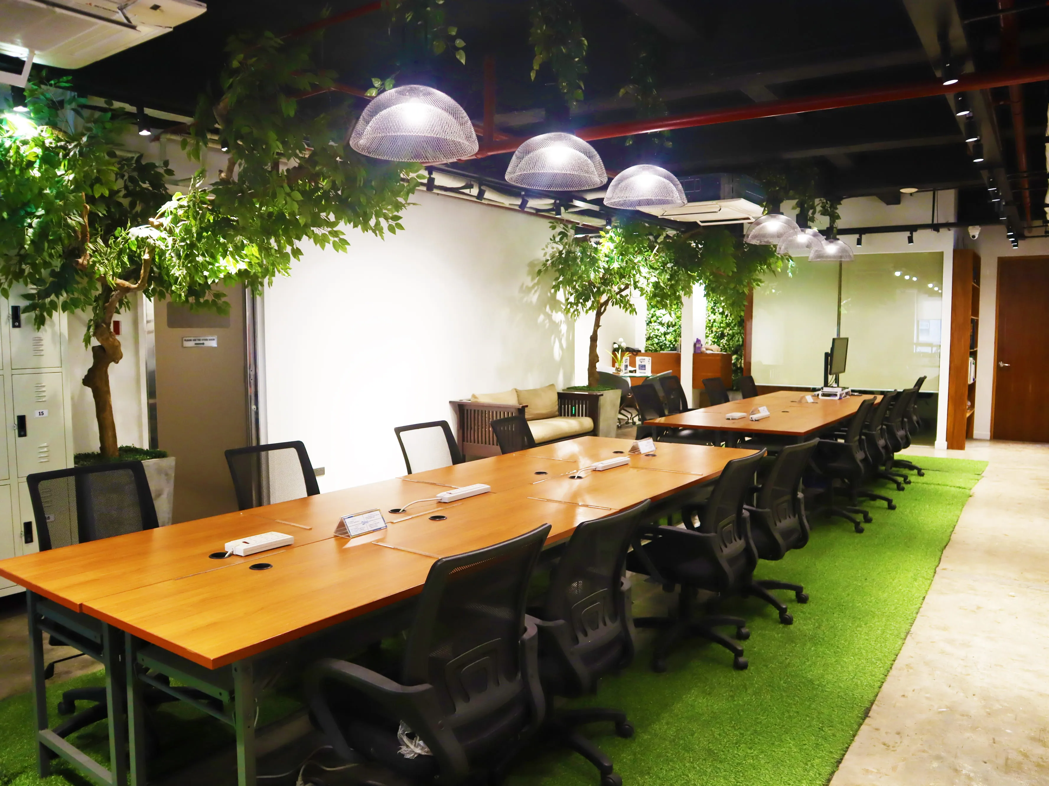 Image of a meeting room with trees on the side.