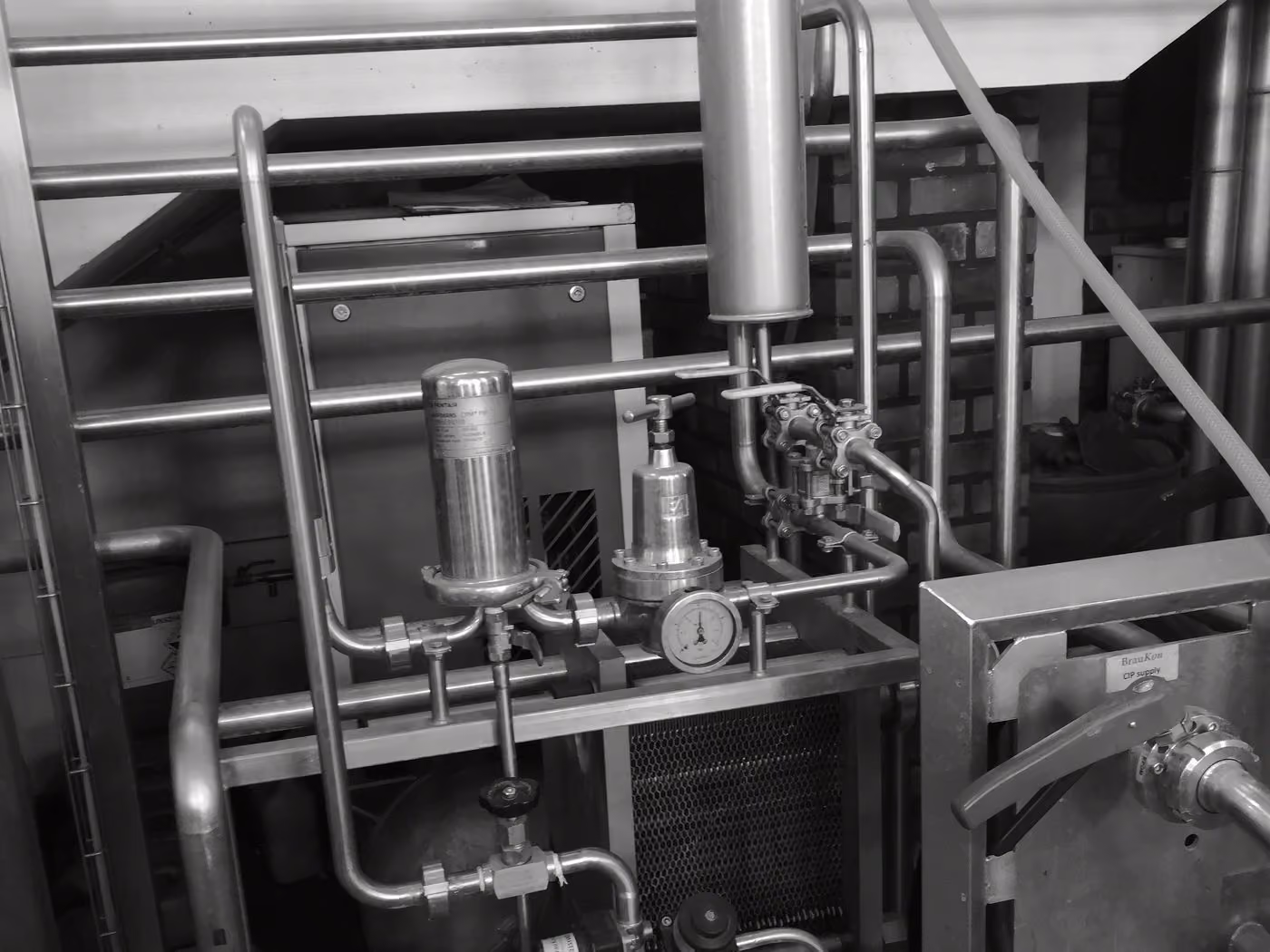 A custom-built pipework skid on a workshop floor, with no OEM badging