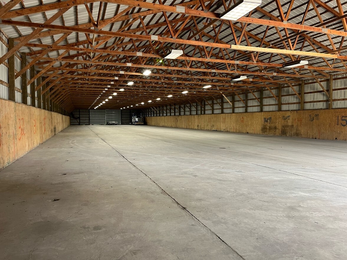 Interior view of clean indoor storage facility with high ceilings and wide aisles#1.9