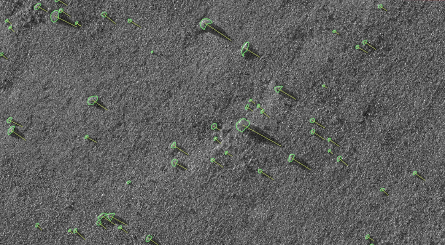 Automated boulder detection and quality control (QC) mapping from high-resolution Synthetic Aperture Sonar (SAS) data, featuring automated target identification outlines and shadow vectors.